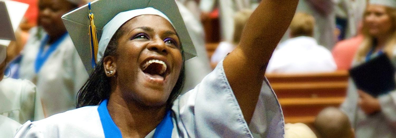 Smiling graduate in cap and gown